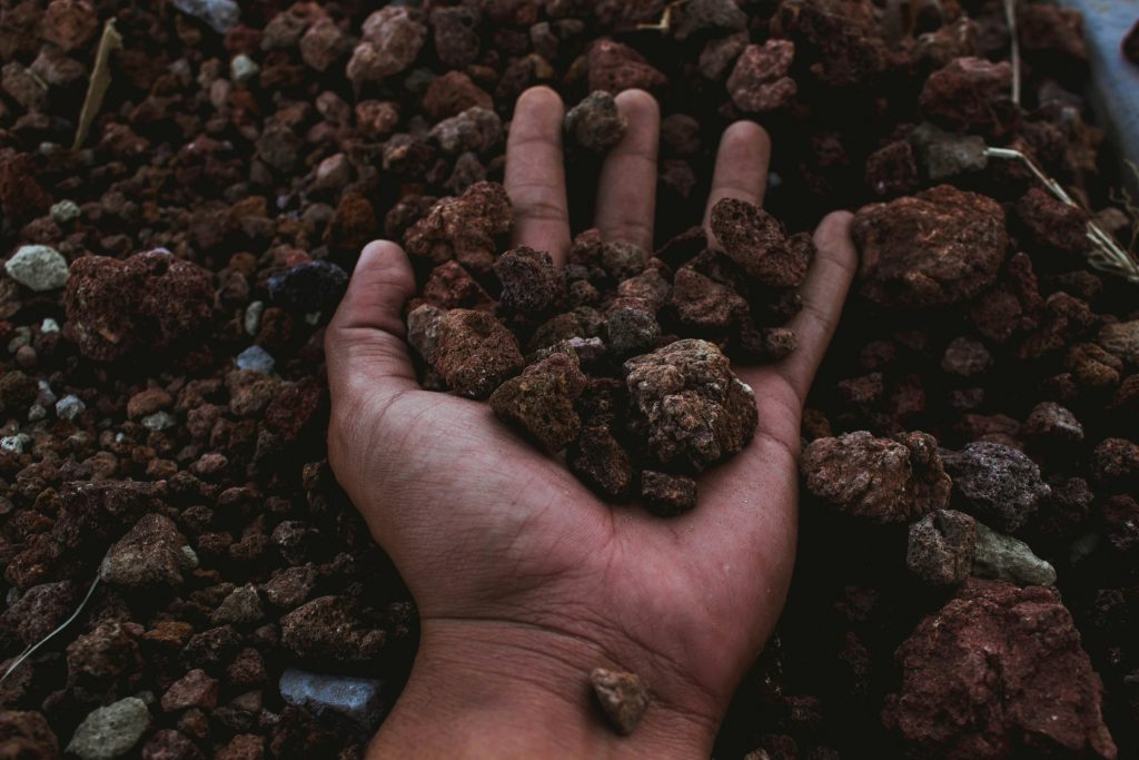 pexels-photo-1254873-1254873 A detailed shot of a hand holding rocky soil, symbolizing earth and nature's raw beauty in Puebla, Mexico.